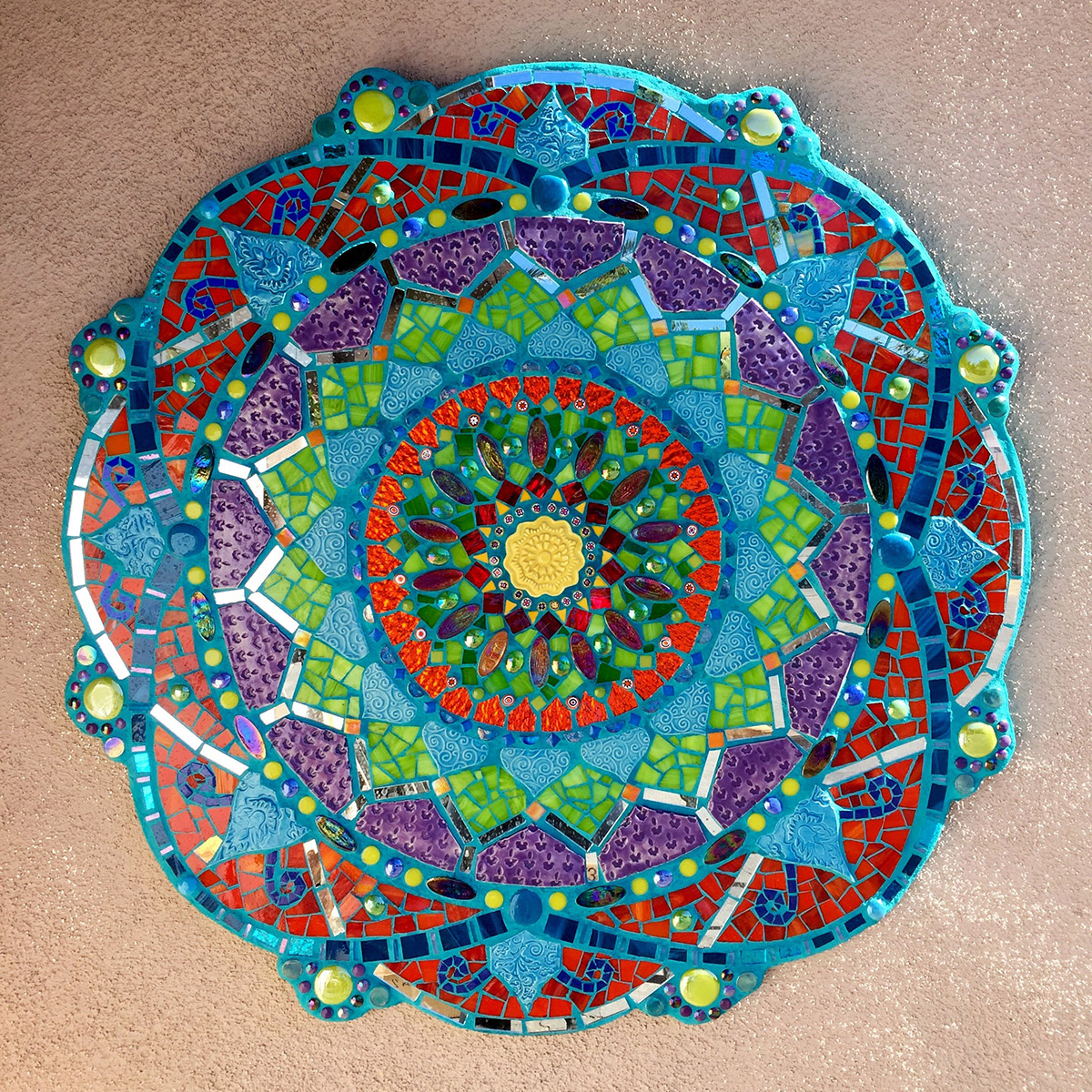 Mosaic Mandala with all the beautiful colors on a pink background