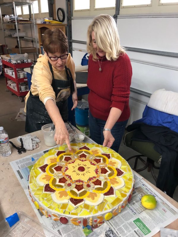 Teaching showing a student how make mosaics circle