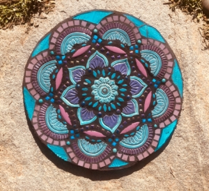 A round blue and purple mandala on the ground.