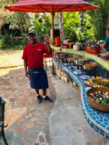 A man standing in front of a table full of food.