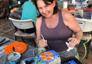 A woman sitting at a table with some cake.