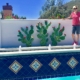 A man standing next to the edge of a pool.