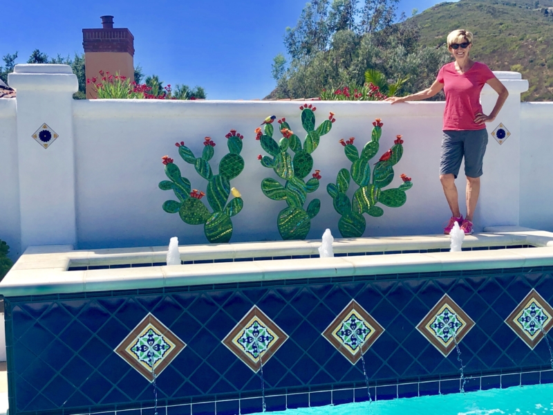 A man standing next to the edge of a pool.