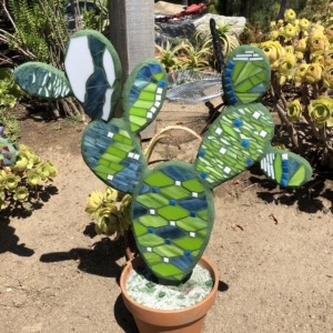 A cactus is painted with green and blue paint.