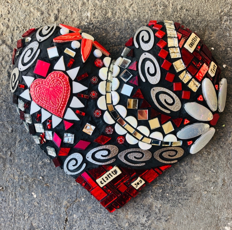 A heart shaped object with red and black designs.