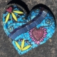 A blue heart with many different designs on it.