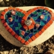A stone with a heart shaped mosaic on it.