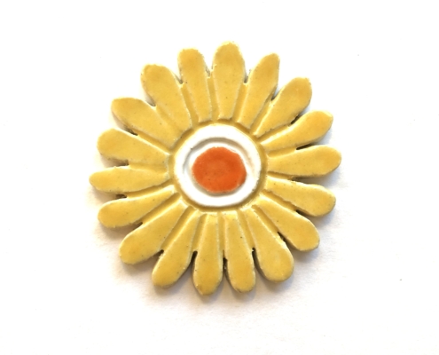 A yellow flower with orange center on white background.